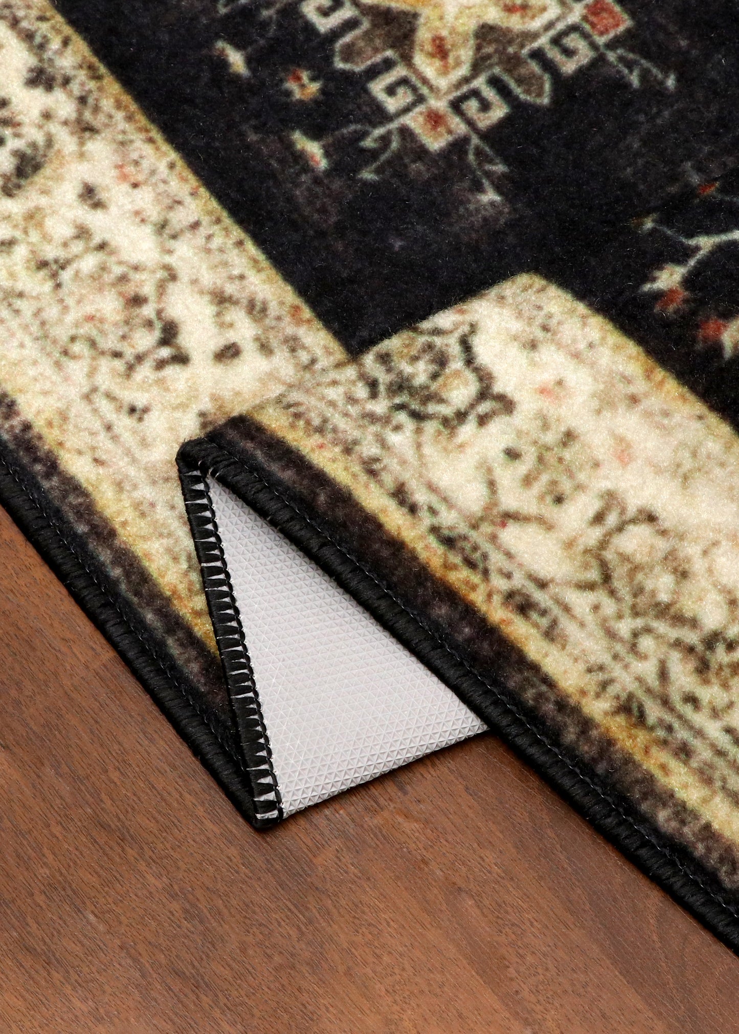 Vintage Black Rug with Cream Border & Intricate Pattern